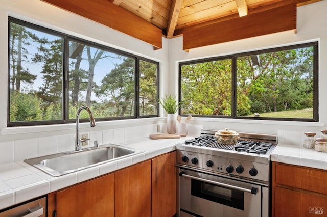 10 Miwok Way, Inverness, CA 94937 - kitchen with stainless steel appliances, a wooden ceiling with exposed beams, plenty of natural light, tile countertops, and brown cabinets
