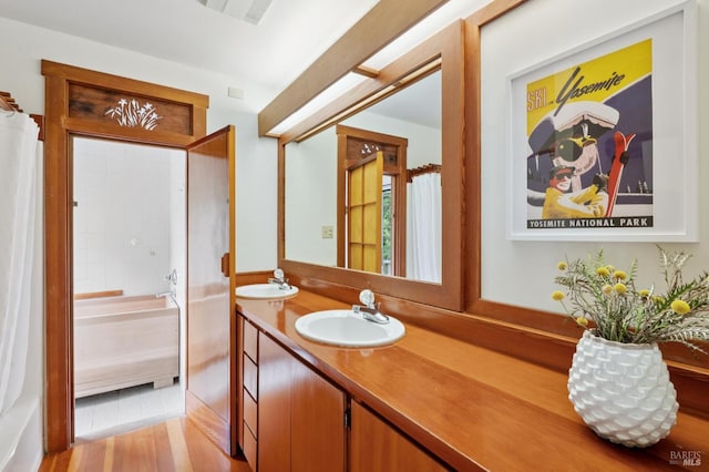 10 Miwok Way, Inverness, CA 94937 - full bath featuring double vanity, a bath, wood finished floors, and curtained shower