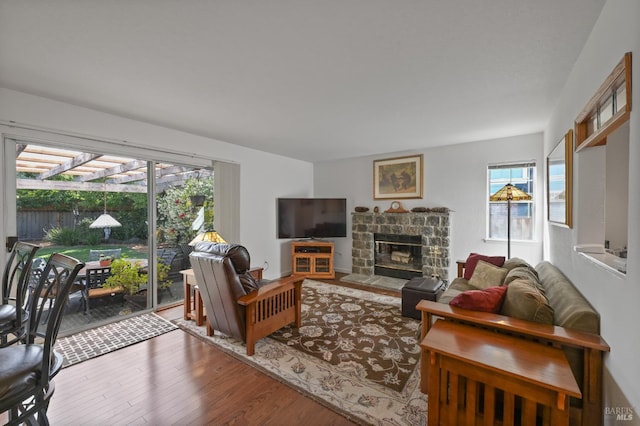 2128 Saint Augustine Cir, Petaluma, CA 94954 - living room with plenty of natural light, wood finished floors, and a stone fireplace