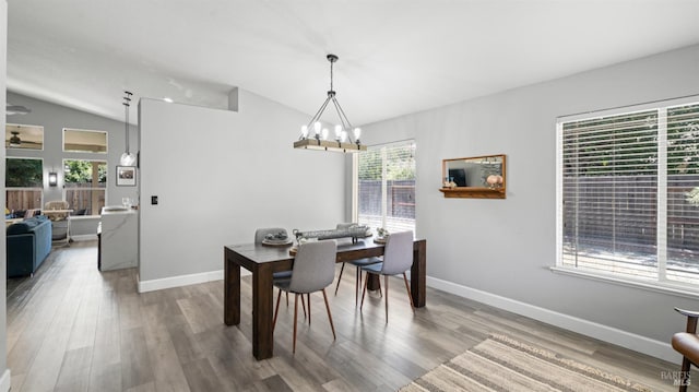 705 Wiegand Way, Dixon, CA 95620 - dining area featuring lofted ceiling, a chandelier, and wood finished floors
