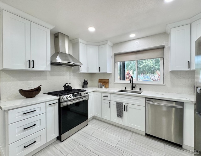 2300 W Park Ave, Napa, CA 94558 - kitchen featuring appliances with stainless steel finishes, wall chimney exhaust hood, decorative backsplash, white cabinetry, and recessed lighting