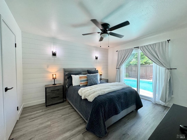 2300 W Park Ave, Napa, CA 94558 - bedroom with access to outside, light wood-style flooring, a ceiling fan, and wood walls
