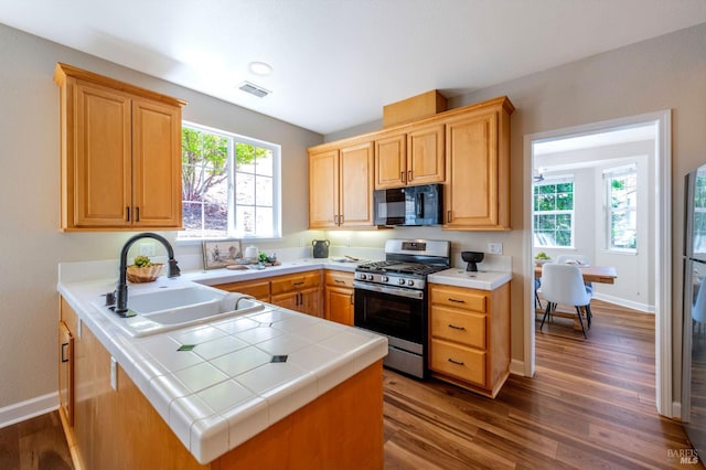 339 Sterling Way, San Rafael, CA 94903 - kitchen featuring gas stove, black microwave, tile countertops, dark wood finished floors, and a peninsula