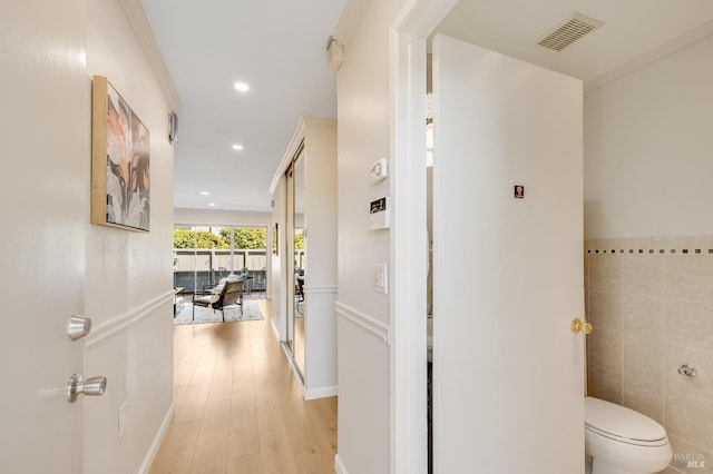 900 Southampton Rd Unit 123, Benicia, CA 94510 - hallway featuring tile walls, light wood finished floors, and recessed lighting