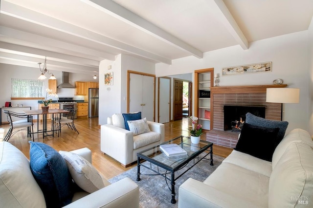 173 Marina Vista Ave, Larkspur, CA 94939 - living room featuring beamed ceiling, light wood-style floors, and a fireplace