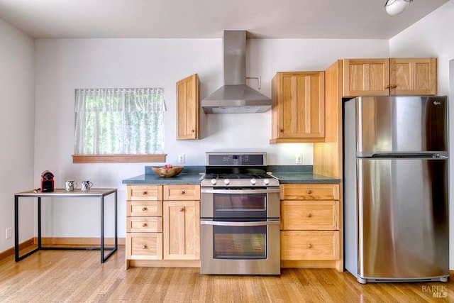 173 Marina Vista Ave, Larkspur, CA 94939 - kitchen featuring stainless steel appliances, wall chimney exhaust hood, dark countertops, and light wood finished floors