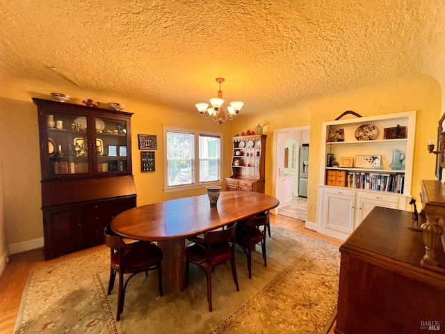 436 S Front St, Rio Vista, CA 94571 - dining area featuring a chandelier, a textured ceiling, and light wood finished floors