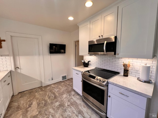 436 S Front St, Rio Vista, CA 94571 - kitchen featuring stainless steel appliances, decorative backsplash, white cabinets, light stone counters, and recessed lighting
