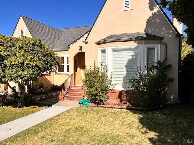 436 S Front St, Rio Vista, CA 94571 - tudor-style house with a front yard, a shingled roof, and stucco siding