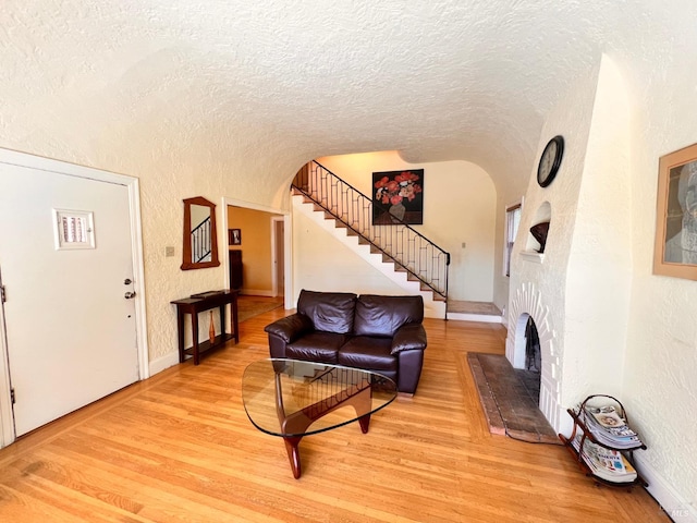 436 S Front St, Rio Vista, CA 94571 - living area with a textured wall, a textured ceiling, stairs, light wood-style floors, and lofted ceiling