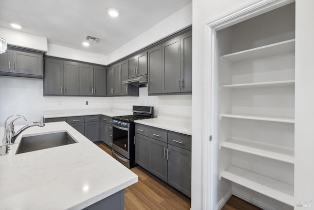 40708 Fremont Blvd, Fremont, CA 94538 - kitchen with stainless steel gas range, under cabinet range hood, dark wood-style flooring, light stone counters, and recessed lighting