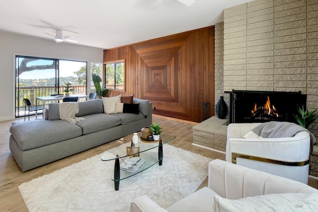 76 Oak Springs Dr, San Anselmo, CA 94960 - living area with a ceiling fan, wood finished floors, wooden walls, and a brick fireplace