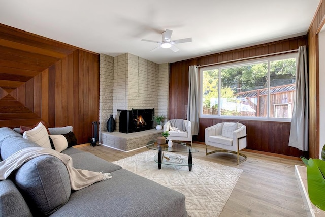 76 Oak Springs Dr, San Anselmo, CA 94960 - living room with a ceiling fan, a brick fireplace, wooden walls, and light wood-style floors
