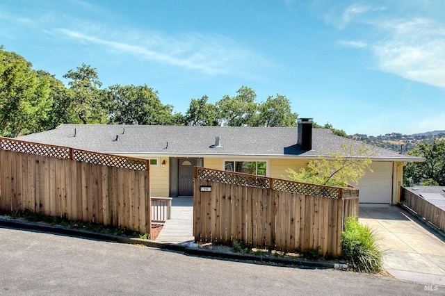 76 Oak Springs Dr, San Anselmo, CA 94960 - ranch-style house with driveway, a chimney, an attached garage, and a fenced front yard