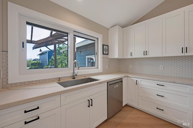 5648 Ver Ni Rd, Sebastopol, CA 95472 - kitchen with dishwasher, vaulted ceiling, white cabinetry, light stone countertops, and decorative backsplash