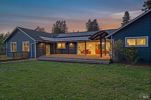 5648 Ver Ni Rd, Sebastopol, CA 95472 - back of property at dusk with roof mounted solar panels, a lawn, a deck, and crawl space