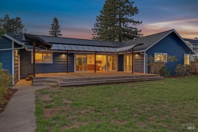 5648 Ver Ni Rd, Sebastopol, CA 95472 - back of property with a standing seam roof, a yard, solar panels, a deck, and a metal roof