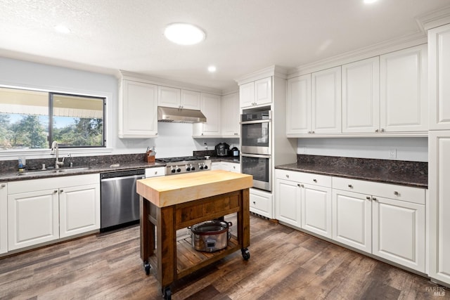 875 White Cottage Rd N, Angwin, CA 94508 - kitchen featuring stainless steel appliances, under cabinet range hood, white cabinetry, wood finished floors, and recessed lighting
