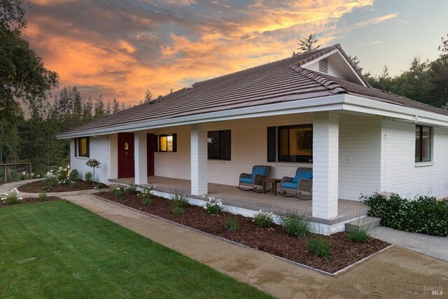 875 White Cottage Rd N, Angwin, CA 94508 - view of front of property featuring a porch, a lawn, a tile roof, and brick siding