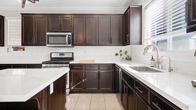 5041 Soprano Cir, Fairfield, CA 94534 - kitchen with stainless steel appliances, light countertops, light tile patterned floors, backsplash, and crown molding