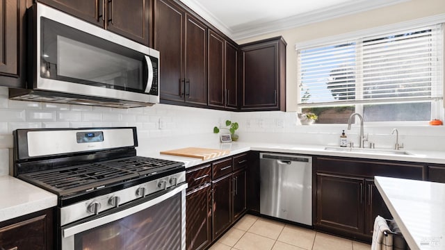 5041 Soprano Cir, Fairfield, CA 94534 - kitchen with stainless steel appliances, ornamental molding, decorative backsplash, light countertops, and dark brown cabinetry