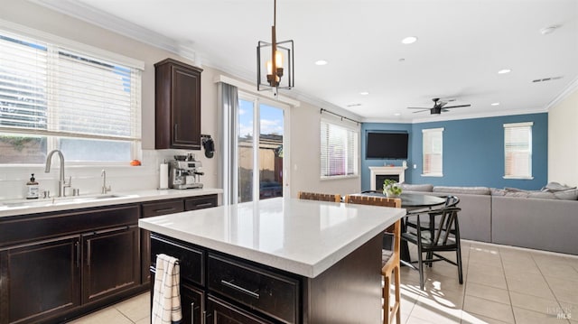 5041 Soprano Cir, Fairfield, CA 94534 - kitchen featuring light tile patterned flooring, crown molding, light countertops, a fireplace, and recessed lighting