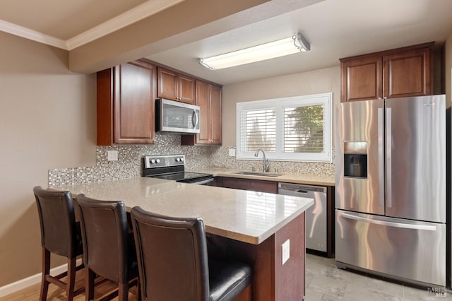 171 Nautical Ct, Vallejo, CA 94574 - kitchen featuring appliances with stainless steel finishes, a peninsula, decorative backsplash, light countertops, and crown molding
