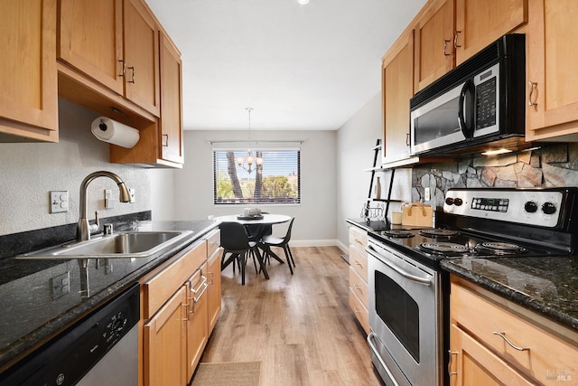 900 Cambridge Dr Unit 77, Benicia, CA 94510 - kitchen with stainless steel appliances, decorative backsplash, light wood finished floors, a chandelier, and dark stone counters