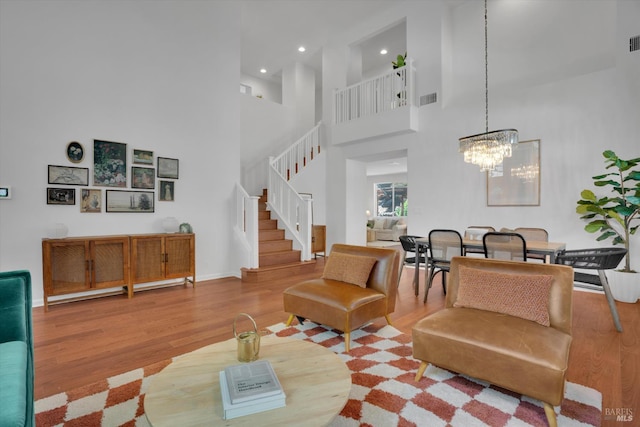 494 Mccall Dr, Benicia, CA 94510 - living room featuring stairs, wood finished floors, recessed lighting, a chandelier, and a high ceiling