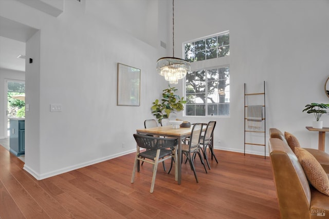494 Mccall Dr, Benicia, CA 94510 - dining area featuring wood finished floors, a towering ceiling, and a chandelier