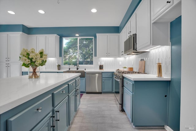 494 Mccall Dr, Benicia, CA 94510 - kitchen featuring stainless steel appliances, blue cabinetry, backsplash, white cabinets, and recessed lighting