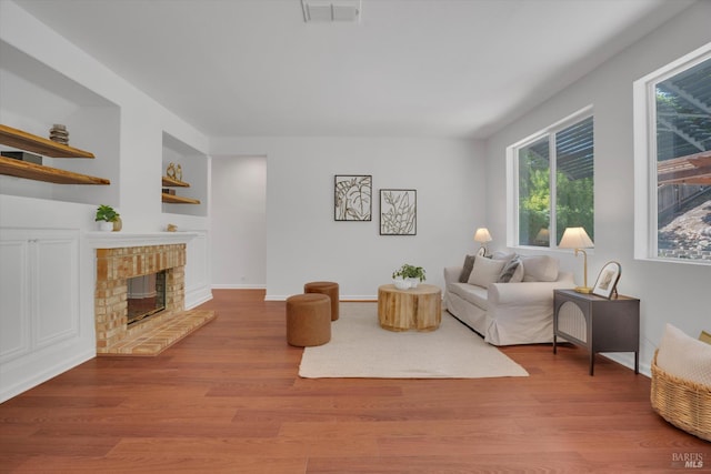 494 Mccall Dr, Benicia, CA 94510 - living area featuring wood finished floors and a brick fireplace