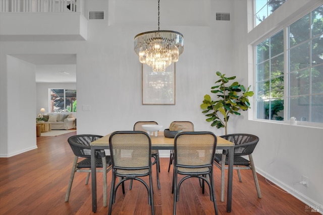 494 Mccall Dr, Benicia, CA 94510 - dining room featuring wood finished floors, a chandelier, and a high ceiling