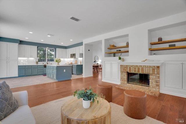 494 Mccall Dr, Benicia, CA 94510 - living room featuring light wood-style flooring, recessed lighting, and a fireplace