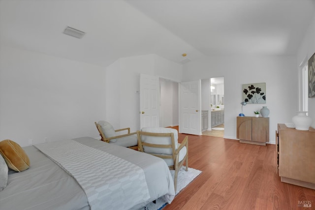 494 Mccall Dr, Benicia, CA 94510 - bedroom with vaulted ceiling, light wood-style floors, and ensuite bath
