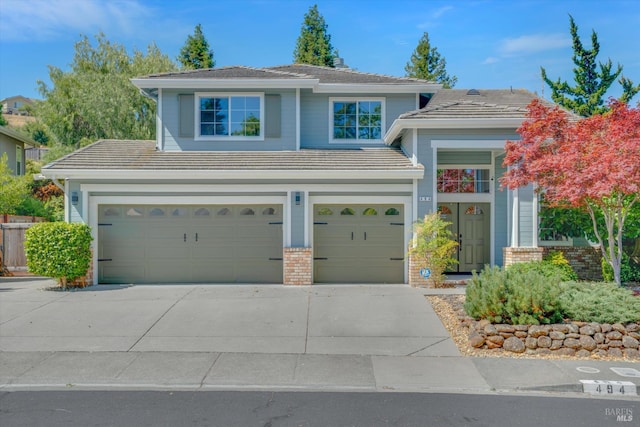 494 Mccall Dr, Benicia, CA 94510 - view of front facade featuring a garage, concrete driveway, a tiled roof, and brick siding