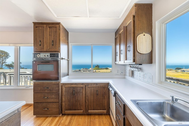 359 Terra Verde, Bodega Bay, CA 94923 - kitchen featuring wall oven, light countertops, dishwasher, and light wood-style flooring