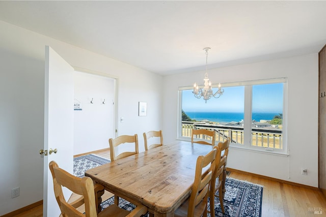 359 Terra Verde, Bodega Bay, CA 94923 - dining room with a chandelier, light wood finished floors, and a water view