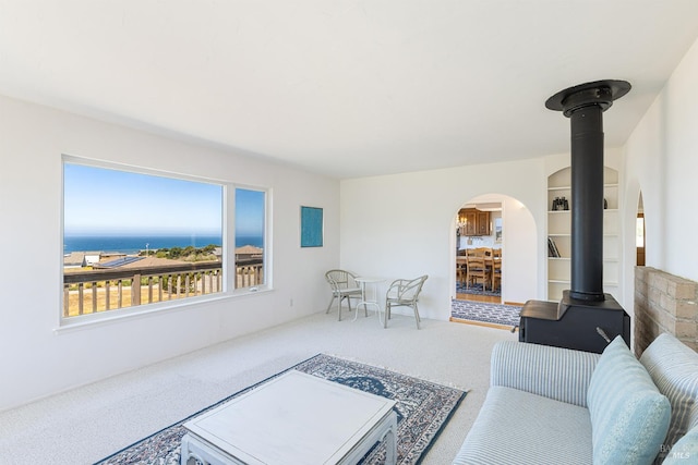 359 Terra Verde, Bodega Bay, CA 94923 - living room with carpet, arched walkways, and a wood stove