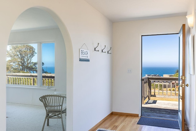 359 Terra Verde, Bodega Bay, CA 94923 - doorway featuring arched walkways, plenty of natural light, wood finished floors, and a water view