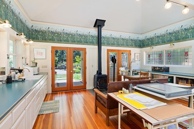 1300 Ink Grade Rd, Pope Valley, CA 94567 - dining room featuring french doors, a wood stove, light wood-style floors, crown molding, and a high ceiling