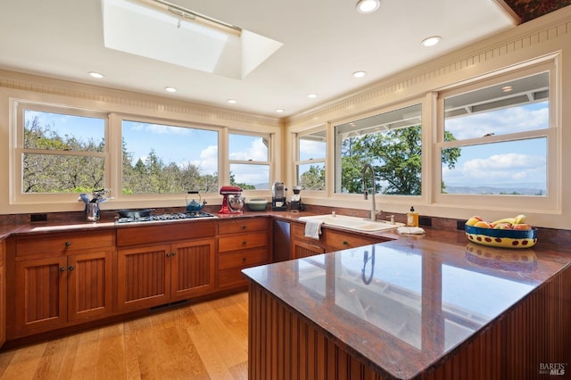 1300 Ink Grade Rd, Pope Valley, CA 94567 - kitchen with stainless steel gas cooktop, brown cabinetry, healthy amount of natural light, dark stone counters, and recessed lighting