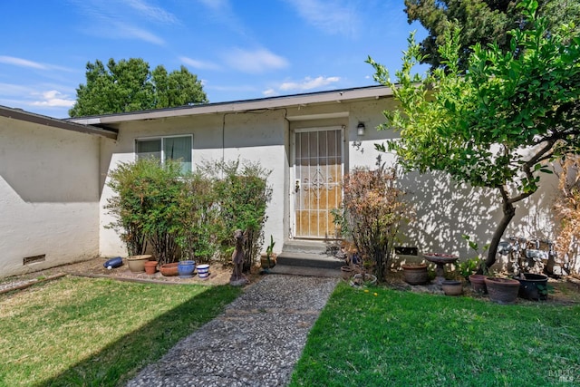 434 E H St, Benicia, CA 94510 - view of exterior entry featuring a yard and stucco siding