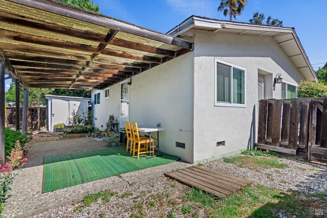434 E H St, Benicia, CA 94510 - back of property featuring stucco siding, a shed, and crawl space