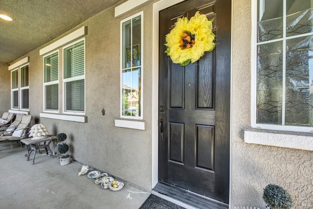 644 Canterbury Cir, Vacaville, CA 95687 - view of exterior entry with stucco siding and a porch