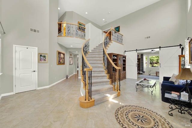 644 Canterbury Cir, Vacaville, CA 95687 - tiled foyer entrance with a barn door, a high ceiling, stairway, and recessed lighting