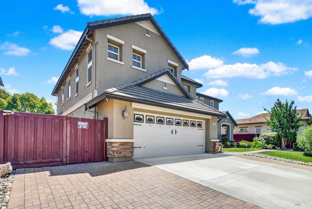 644 Canterbury Cir, Vacaville, CA 95687 - view of front of property with stucco siding, driveway, stone siding, and a tiled roof