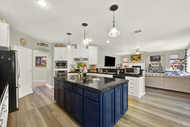 644 Canterbury Cir, Vacaville, CA 95687 - kitchen with appliances with stainless steel finishes, open floor plan, blue cabinets, a kitchen island, and a ceiling fan