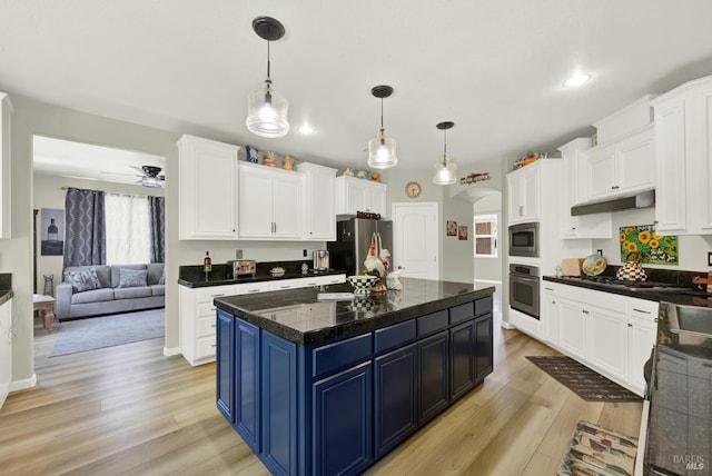 644 Canterbury Cir, Vacaville, CA 95687 - kitchen with stainless steel appliances, light wood-type flooring, blue cabinets, under cabinet range hood, and white cabinets