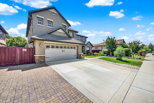644 Canterbury Cir, Vacaville, CA 95687 - traditional-style house featuring stucco siding, driveway, stone siding, an attached garage, and a tile roof